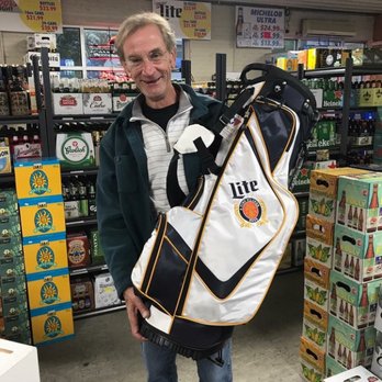 Olde Towne Beverage - a man holding a golf bag - Beer, Wine & Spirits Near Me - New Cumberland, Pennsylvania Olde Towne Beverage - a man holding a golf bag - Beer, Wine & Spirits Near Me - New Cumberland, Pennsylvania