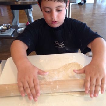 Out of Thyme Kitchen Studio - Rolling out pizza dough at Family Night:Pizza Party class July '17 - Food Near Me - Cincinnati, Ohio Out of Thyme Kitchen Studio - Rolling out pizza dough at Family Night:Pizza Party class July '17 - Food Near Me - Cincinnati, Ohio