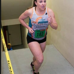 Tri-Covery Massage & Flexibility - Sponsored Athlete Kacey running up the stairs for charity to fight for cleaner air