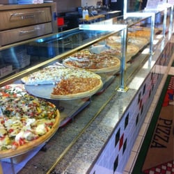 Bravo Pizza of Avondale - The monster row of pizza's when you walk in.