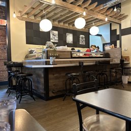 A view of the sushi bar, where master sushi craftspeople prepare excellent sushi.