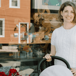 Nurtured: Baby, Kids, Family - Shop Nurtured for all your baby gear needs. Woman stands outside of Nurtured store with a stroller.