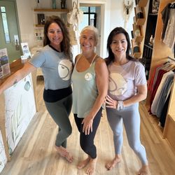 Wilmington Yoga - Co-Owner Heather and two students all in WYC merch