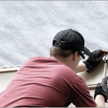 Warner Brothers Siding - a man fixing a window - General Contractors Near Me - Marion, Iowa Warner Brothers Siding - a man fixing a window - General Contractors Near Me - Marion, Iowa