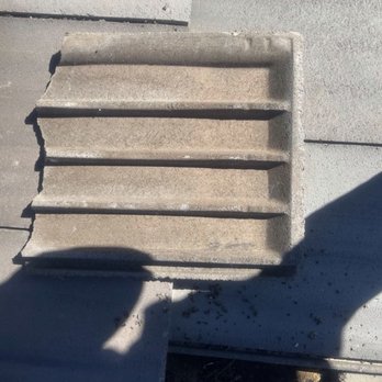 1Solar Roofing - One of the damaged roof tiles next to the 1Solar array. - Solar Installation Near Me 1Solar Roofing - One of the damaged roof tiles next to the 1Solar array. - Solar Installation Near Me