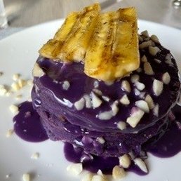 Ube mochi pancake with white chocolate ube sauce and macadamia nuts