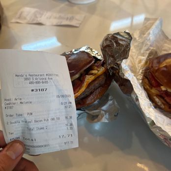 Wendy's - a person holding a receipt and a sandwich - Burgers Near Me - Chandler, Arizona