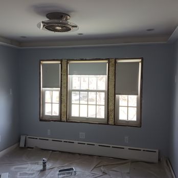 DH Renovation - a room with two windows and a fan - General Contractors Near Me DH Renovation - a room with two windows and a fan - General Contractors Near Me