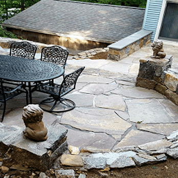 Supreme Green Landscaping - a patio with a table and chairs - Landscaping Near Me - Danbury, Connecticut Supreme Green Landscaping - a patio with a table and chairs - Landscaping Near Me - Danbury, Connecticut