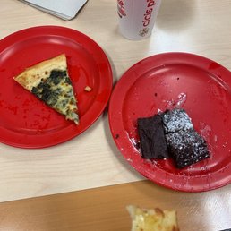 two slices of pizza on red plates