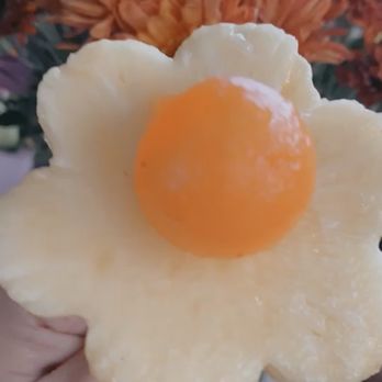 Edible Arrangements - a person holding an egg in the shape of a flower - Gift Shops Near Me - Riverside, California