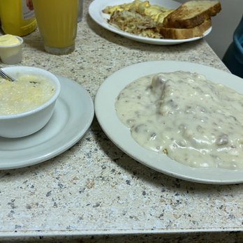 Bert & Betty's Kitchen - Side of grits with cheese and small side of biscuits with sausage gravy. Omelette, hash browns, side of sourdough toast in back. - American Near Me - Fillmore, Indiana Bert & Betty's Kitchen - Side of grits with cheese and small side of biscuits with sausage gravy. Omelette, hash browns, side of sourdough toast in back. - American Near Me - Fillmore, Indiana