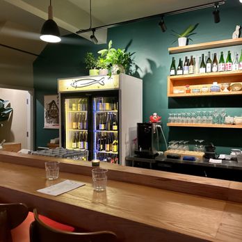 Mhel - a bar with wine glasses on the counter - Korean Near Me - Toronto, Ontario