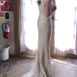 Wedding dress with train and no noticeable bustle attachment. Wedding dress with train and no noticeable bustle attachment.