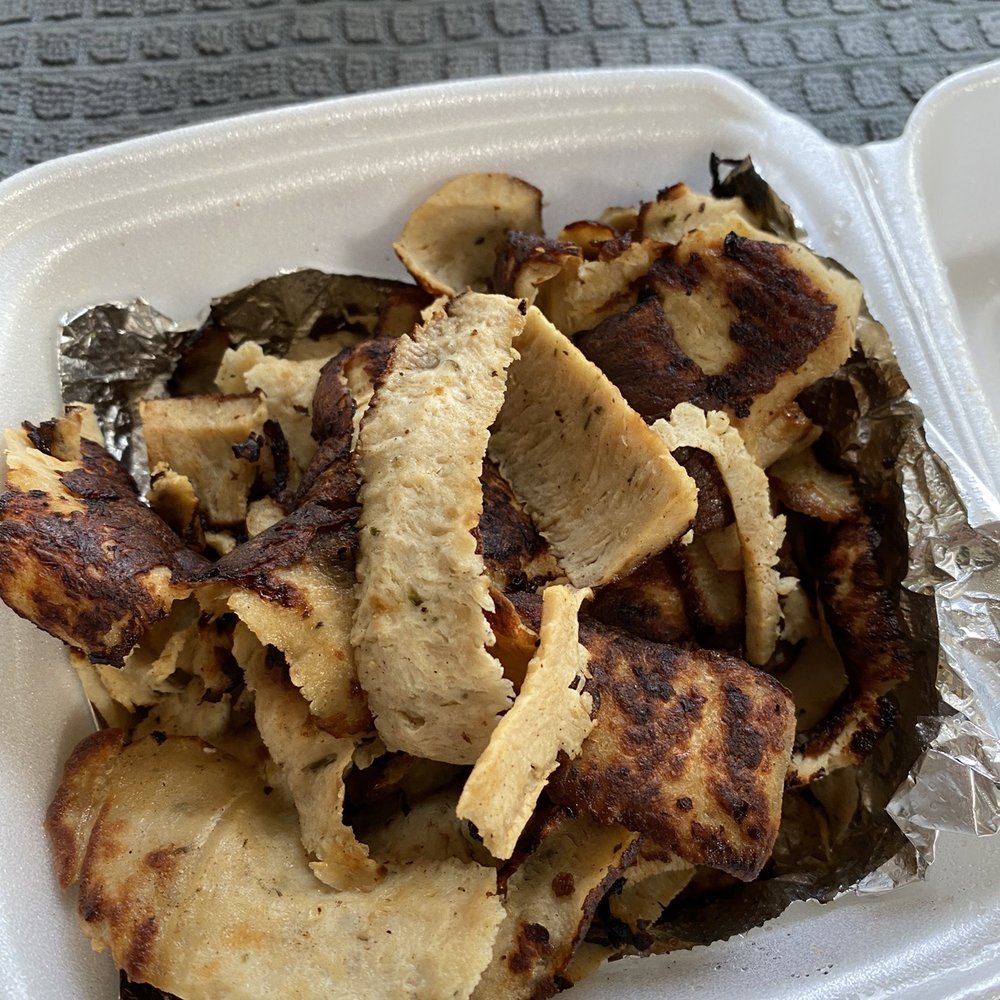 a plate of food in a styrofoam container