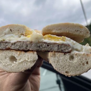 West End Bagels - a hand holding a half eaten sandwich - Bagels Near Me - Clifton Park, New York West End Bagels - a hand holding a half eaten sandwich - Bagels Near Me - Clifton Park, New York