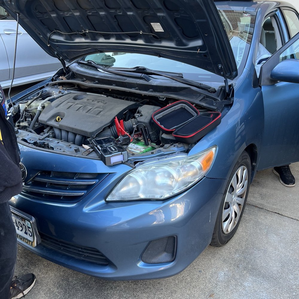 Rick's Mobile Mechanic Services - Rick and his assistant running tests on our battery and looking for car faults before making his recommendation. - Auto Repair Near Me
