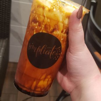 Simplicitea - Brown sugar milk cap tea + straw + hand - Bubble Tea Near Me - St Paul, Minnesota