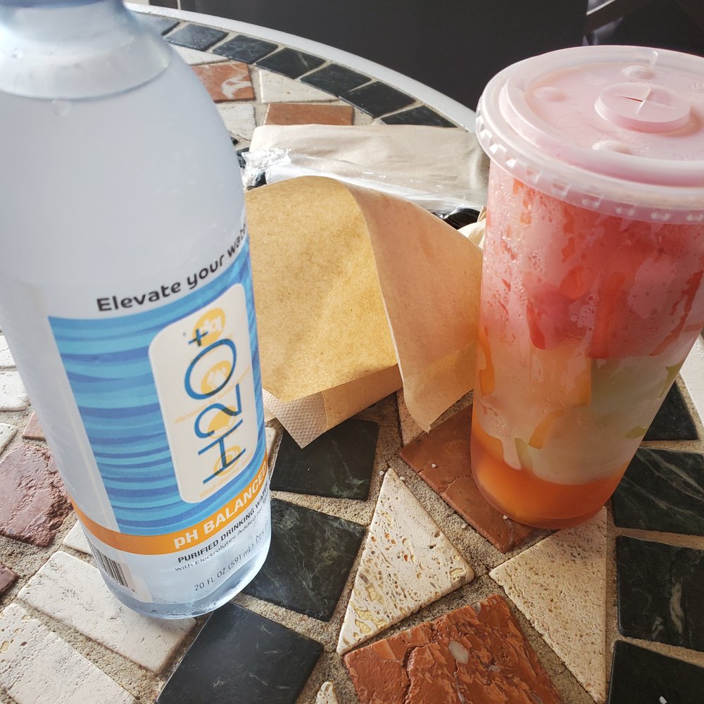 Doc Sugrue's Desert Kebab House - a water bottle and a drink on a mosaic table - Imported Food Near Me - Orlando, Florida Doc Sugrue's Desert Kebab House - a water bottle and a drink on a mosaic table - Imported Food Near Me - Orlando, Florida