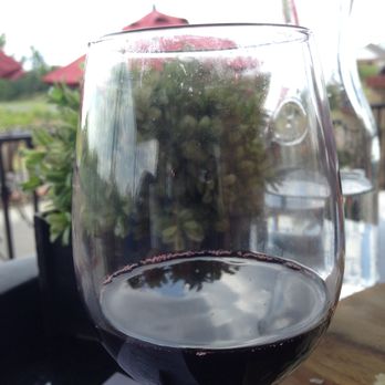 Clauren Ridge Vineyard and Winery - A glass of sweet red wine at the Clauren Ridge Vineyard and Winery tasting room. - Venues & Event Spaces Near Me - Edmond, Oklahoma Clauren Ridge Vineyard and Winery - A glass of sweet red wine at the Clauren Ridge Vineyard and Winery tasting room. - Venues & Event Spaces Near Me - Edmond, Oklahoma