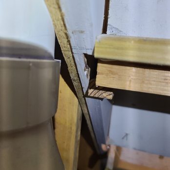 Imperial Home Improvement - a piece of wood being cut - Drywall Installation & Repair Near Me