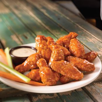 Montana's - a plate of buffalo wings and carrots - Comfort Food Near Me - Oakville, Ontario
