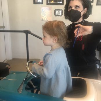 The Knotty Kids Salon - Haircut in a classic car - watching her favorite cartoon on Netflix. - Kids Hair Salons Near Me - Denver, Colorado The Knotty Kids Salon - Haircut in a classic car - watching her favorite cartoon on Netflix. - Kids Hair Salons Near Me - Denver, Colorado