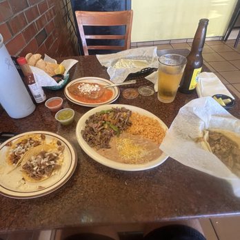 Carnitas La Villa - Carnitas and adobada tacos (bottom left), pork green chile taco (bottom right), chile relleno (top), steak fajitas plate (center) - Mexican Near Me - Newport Beach, California Carnitas La Villa - Carnitas and adobada tacos (bottom left), pork green chile taco (bottom right), chile relleno (top), steak fajitas plate (center) - Mexican Near Me - Newport Beach, California