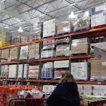 Costco - a woman and a man in a grocery store - Wholesale Stores Near Me - South Windsor, Connecticut