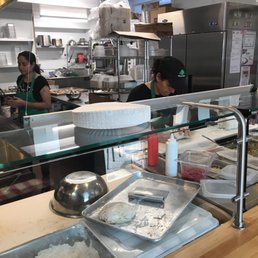 people in a kitchen preparing food