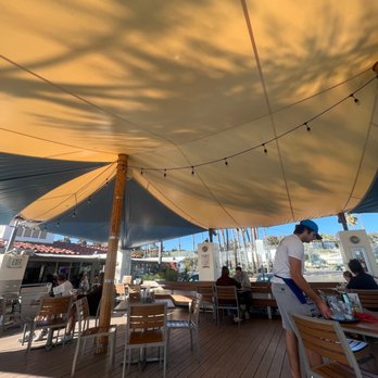 Shoreline Cafe - people sitting at tables under a canopy - Seafood Near Me - Santa Barbara, California