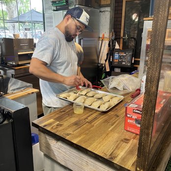 Empanada & Co - a man preparing food - Food Delivery Services Near Me