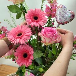 Drummers Garden Center & Floral - Florist arranging a Mother's Day arrangement of gerbera daisies and roses.