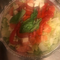 This is what they call a caprese salad??? Chopped up tiny pieces of mozzarella!?? A joke! And soggy basil! Gross!