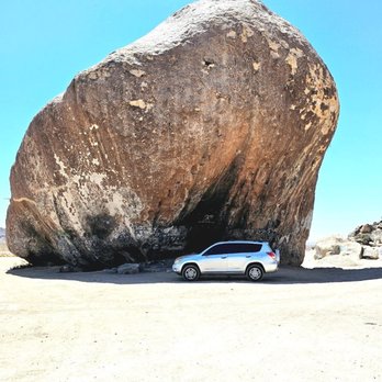Giant Rock - A car dwarfed by this amazing rock. - Local Flavor Near Me