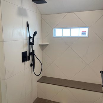 Alpha Tile - a shower and bench in a bathroom - Tiling Near Me - Overland Park, Kansas