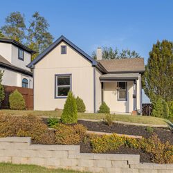 Simple Project KC - Freshly maintained landscape with a clean retaining wall and healthy shrubs for curb appeal.