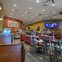 Pizza Ranch - Seating area. The open area, they had alot of private rooms and big banquet rooms. The TV on top of the door is a camera for the arcade