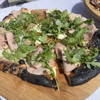 Patulli Pizza Mobile - a sliced pizza on a cutting board - Caterers Near Me Patulli Pizza Mobile - a sliced pizza on a cutting board - Caterers Near Me