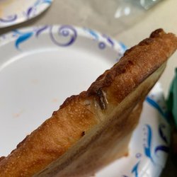 Little Caesars Pizza - Roach embedded into pizza crust.