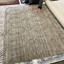 1001 Area Rugs Galore - Rugs hung to look through, and rugs all around. Many soft wool rugs.