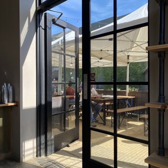 Shawarmaji - Outdoor patio seating area with shade - Middle Eastern Near Me - Oakland, California Shawarmaji - Outdoor patio seating area with shade - Middle Eastern Near Me - Oakland, California