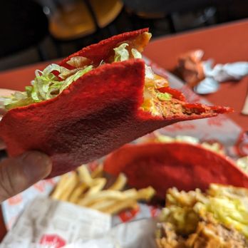 Jack in the Box - a hand holding a taco - Fast Food Near Me - Albuquerque, New Mexico