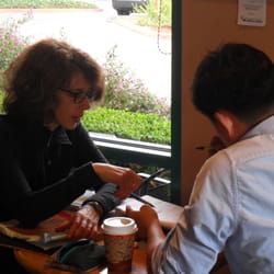 English Language Communication Coaching by SEG - Reviewing student's writing at a Mountain View cafe.