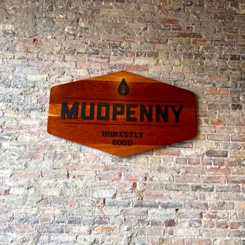 MudPenny - a sign on a brick wall - New American Near Me - Grand Rapids, Michigan