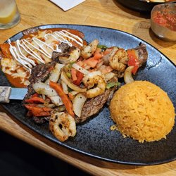Los Potrillos - Ribeye Superior - Medium. Cooked perfectly. Came with 5 shrimp, onions, bell peppers, & tomatoes. Chicken enchilada and rice or beans.