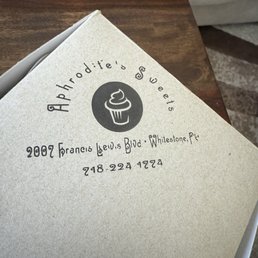 A menu from Aphrodite's Sweets bakery displays the logo, address at 2007 Francis Lewis Blvd, Whitestone, NY, and phone number 718-224-1724.
