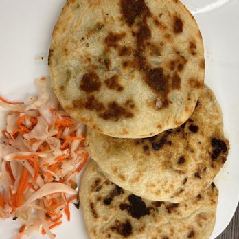 Pupuseria Cafe - three flatbreads on a white plate - Salvadoran Near Me - Chicago, Illinois Pupuseria Cafe - three flatbreads on a white plate - Salvadoran Near Me - Chicago, Illinois