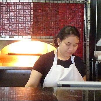 Tomatina - The kitchen showcases a large, brick-lined pizza oven that's fired by propane. - Italian Near Me - Roseville, California Tomatina - The kitchen showcases a large, brick-lined pizza oven that's fired by propane. - Italian Near Me - Roseville, California