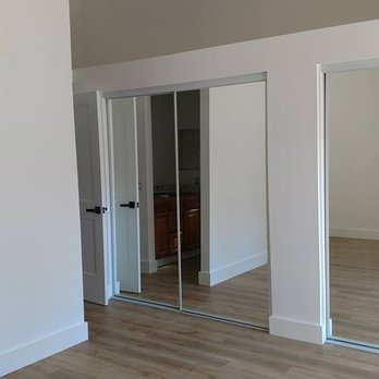 Hoey Construction - an empty room with mirrored doors - General Contractors Near Me Hoey Construction - an empty room with mirrored doors - General Contractors Near Me